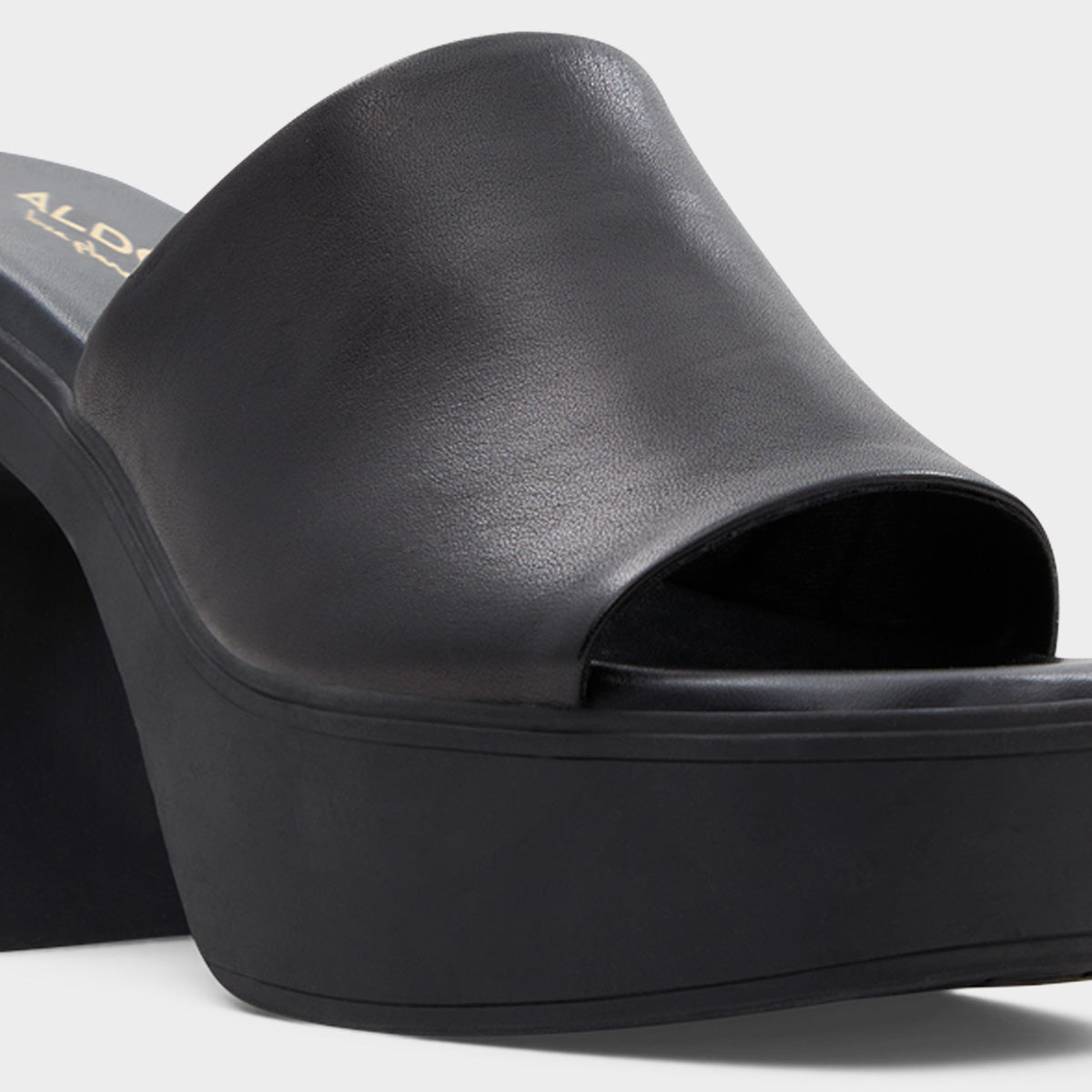 Black open-toe platform sandal on a light gray background