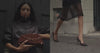 A video of a woman walking down the street in a brown jacket and brown pump heels, carrying a matching brown suede clutch for an effortlessly polished look.