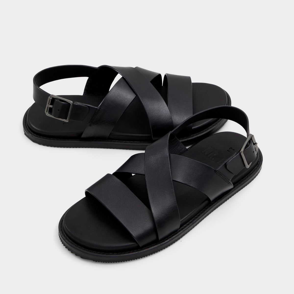 Highlighted view of a pair of Black Fredo Flat sandalss