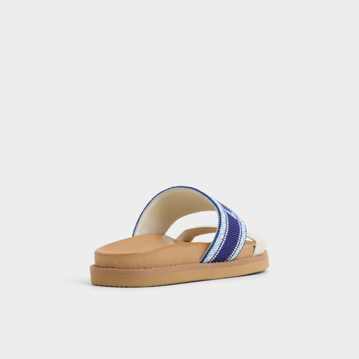Three-quarter angle of White/Blue Beachvacay Slide sandal's back side