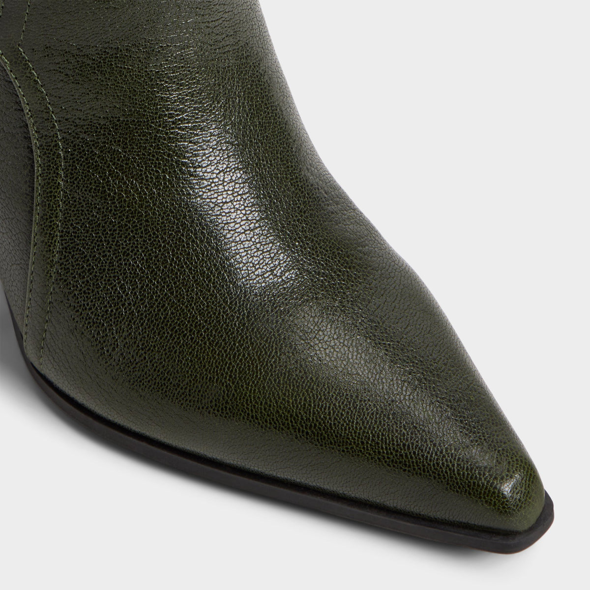 Close-up of the Dark green Saddle Knee-high boot