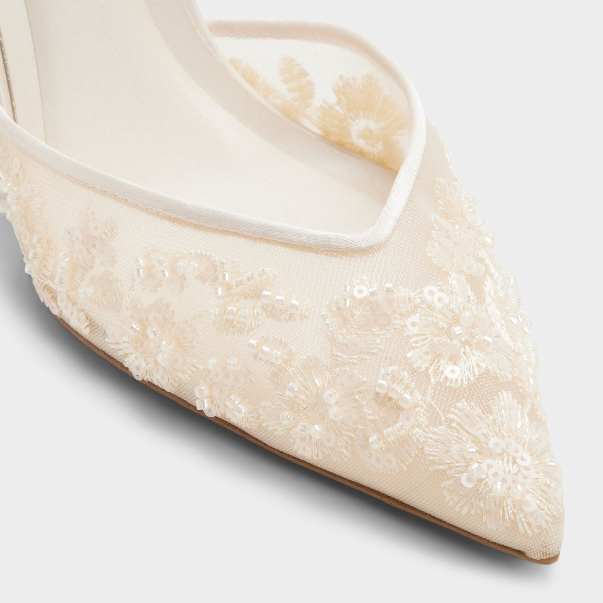 Close-up of the Cream Carollina Slingback high heel