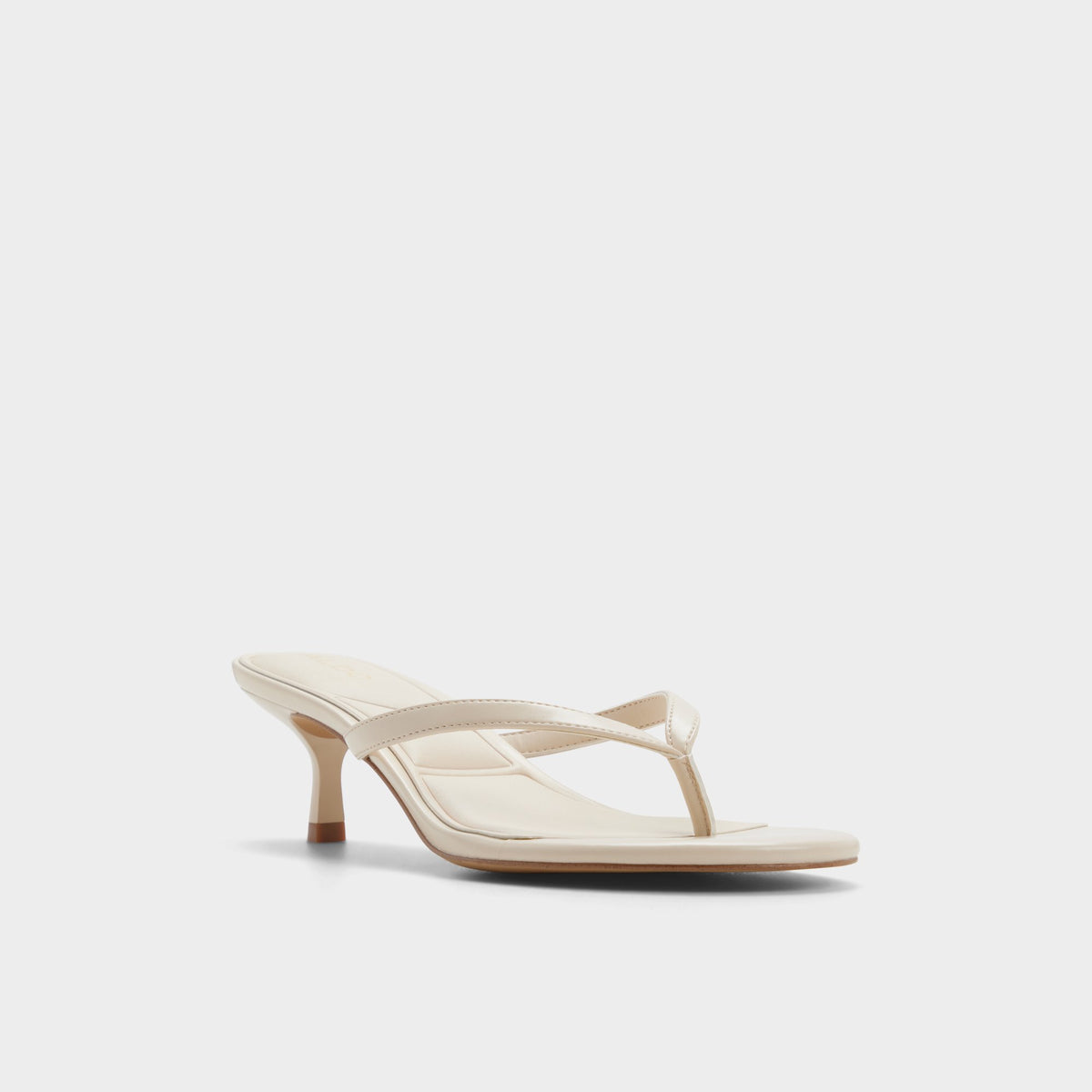 Three-quarter angle of Cream Lift Heeled flip flop's front side
