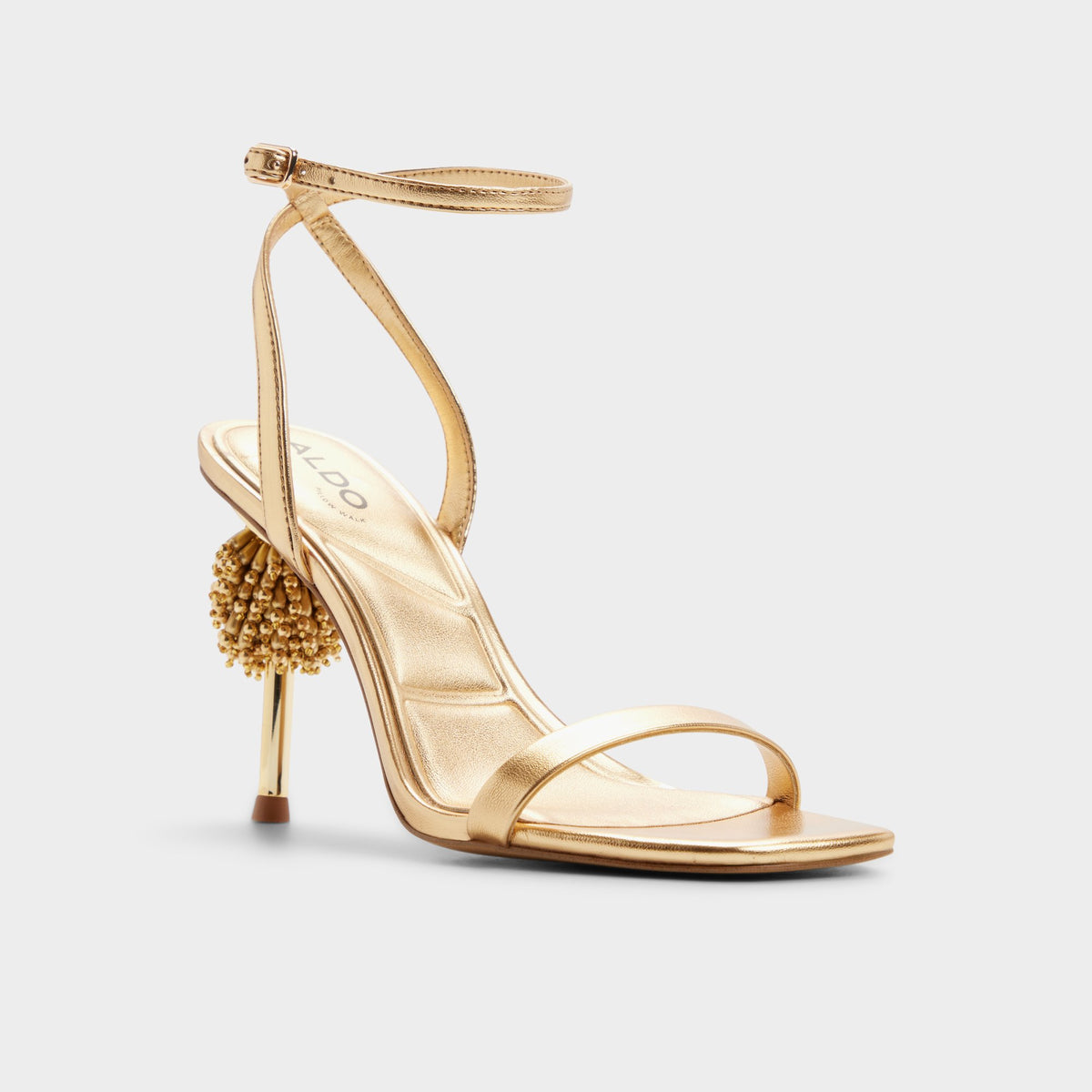 Three-quarter angle of Gold Aurorae Strappy heeled sandal's front side