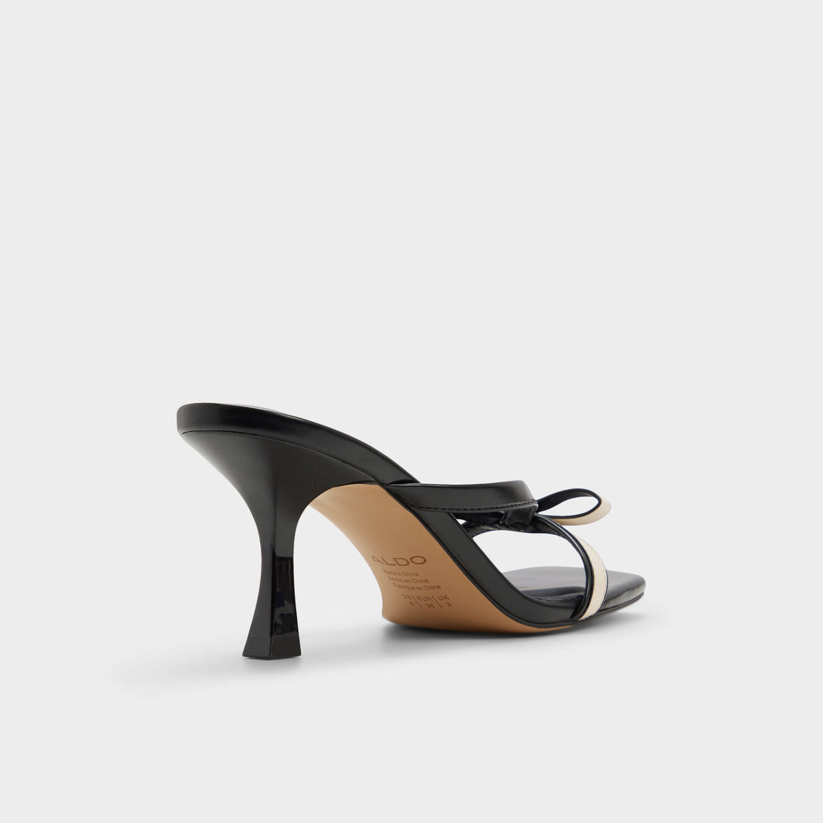 Three-quarter angle of Beige combo Elanore Heeled mule's back side